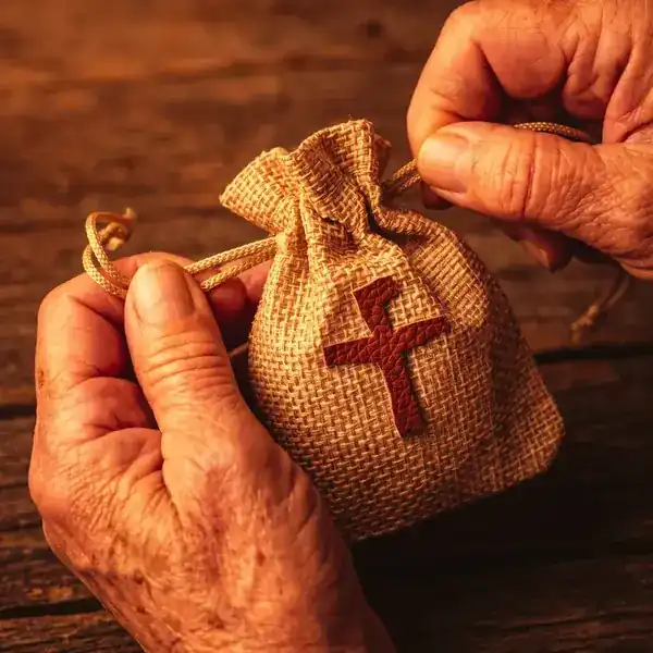 Mãos amarrando o nó do cordão da Mochilinha da Fé